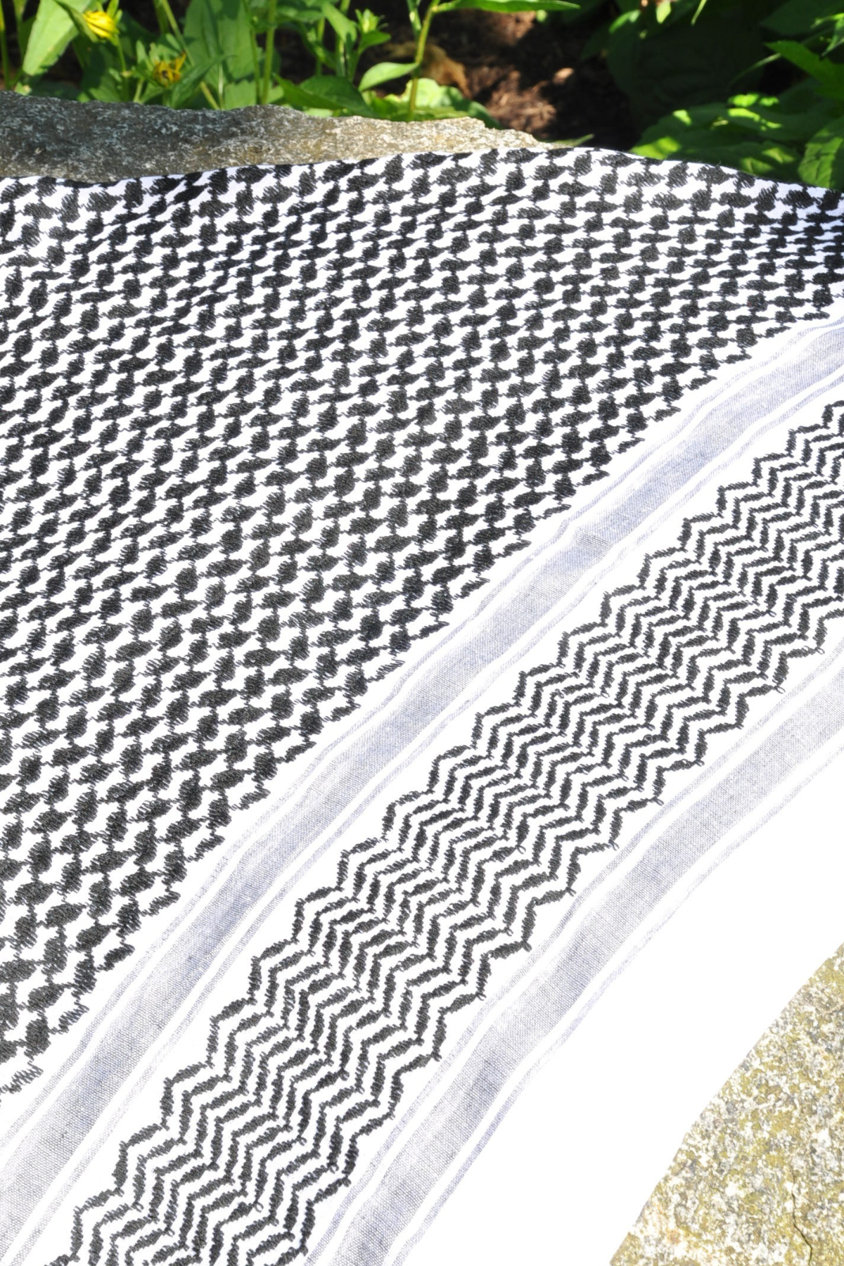 this authentic black and white Keffiyeh features beautifully crafted tassels and a bold design. A statement piece that showcases heritage and tradition in every thread.