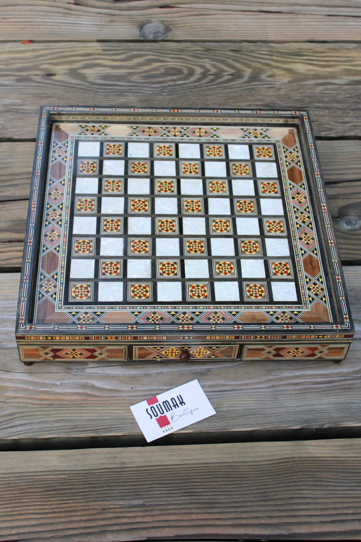 Full view of the closed handcrafted square chess board, featuring both drawers closed, showcasing its elegant design, intricate wood pattern, and polished finish, highlighting the beauty and craftsmanship of the set.