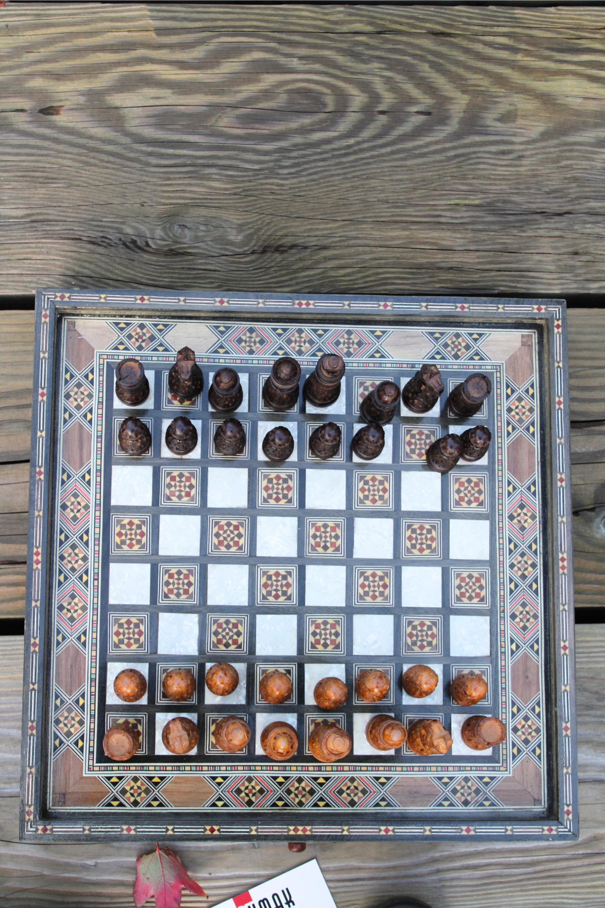 Top-down view of the handcrafted chess board set, showcasing the arrangement of intricate resin chess pieces on the beautifully crafted wood surface, emphasizing the elegant design and gameplay readiness.