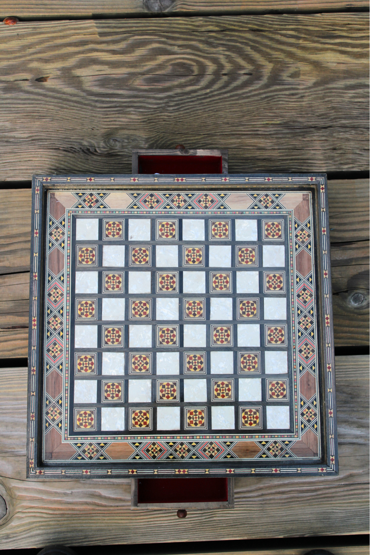 op-down view of the handcrafted chess board set with both drawers open, highlighting the elegant wood finish and spacious storage areas, showcasing the board's craftsmanship without any chess pieces.