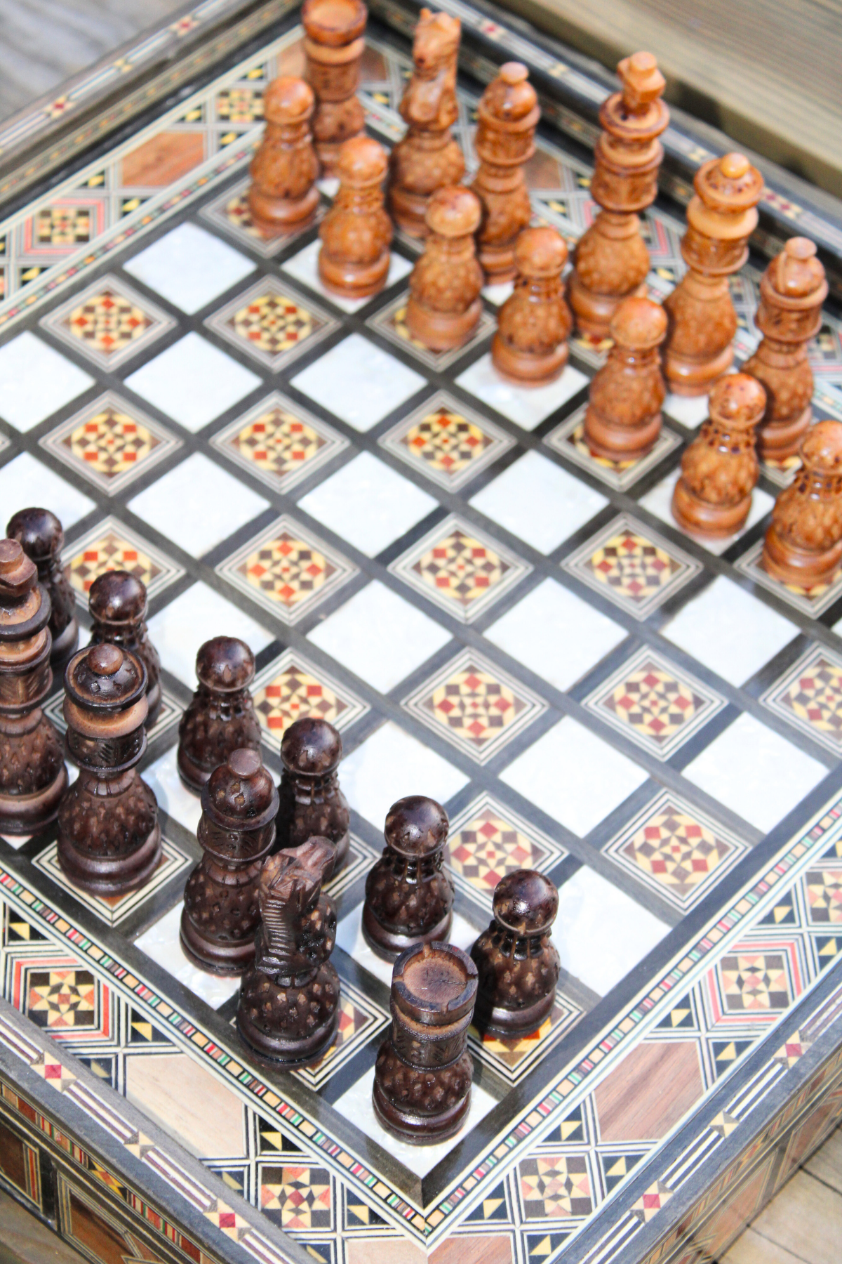 The chess board set up for a game, featuring resin chess pieces in play, demonstrating the set's functionality and aesthetic appeal.