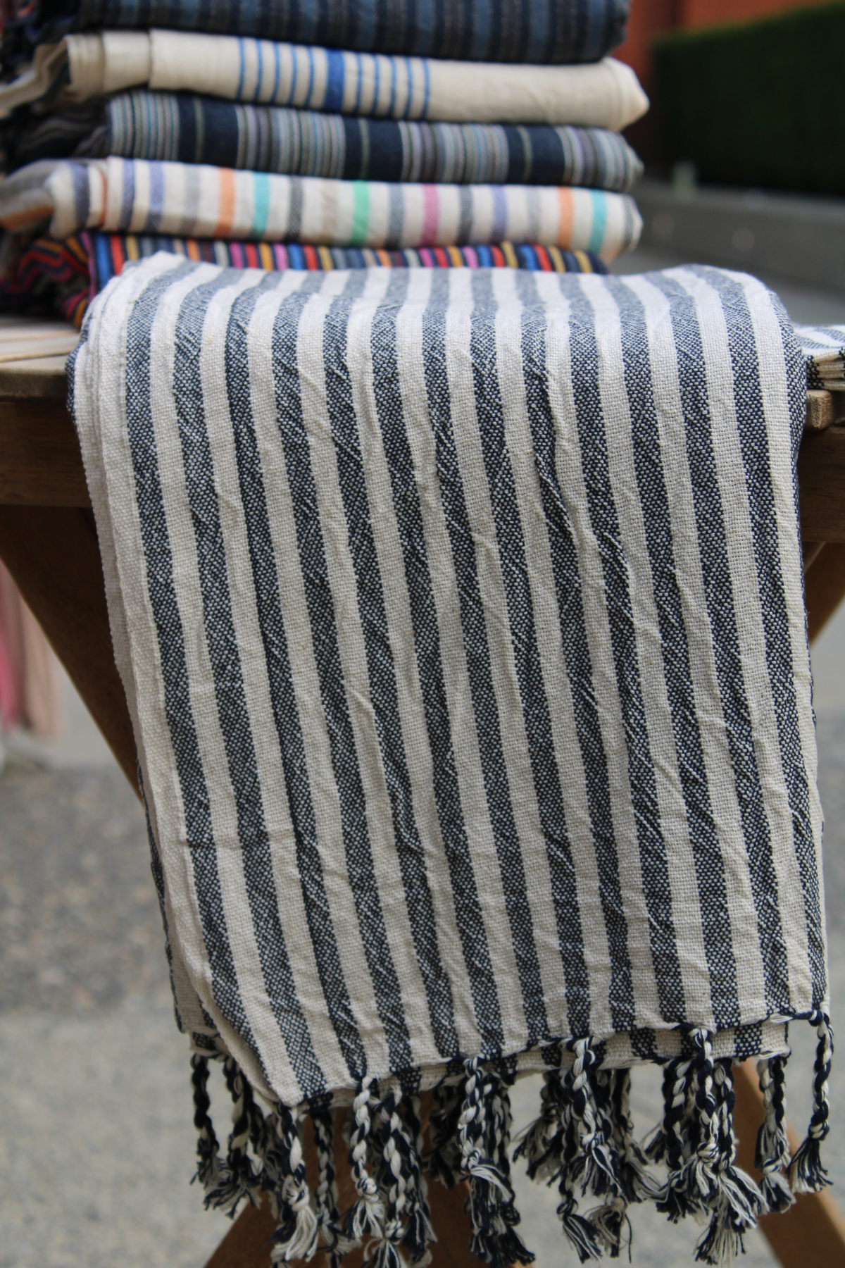  Displaying our Turkish Hamam Towel with charcoal stripes in a sleek, vertical folded arrangement. Perfect as a towel, throw, or shawl.
