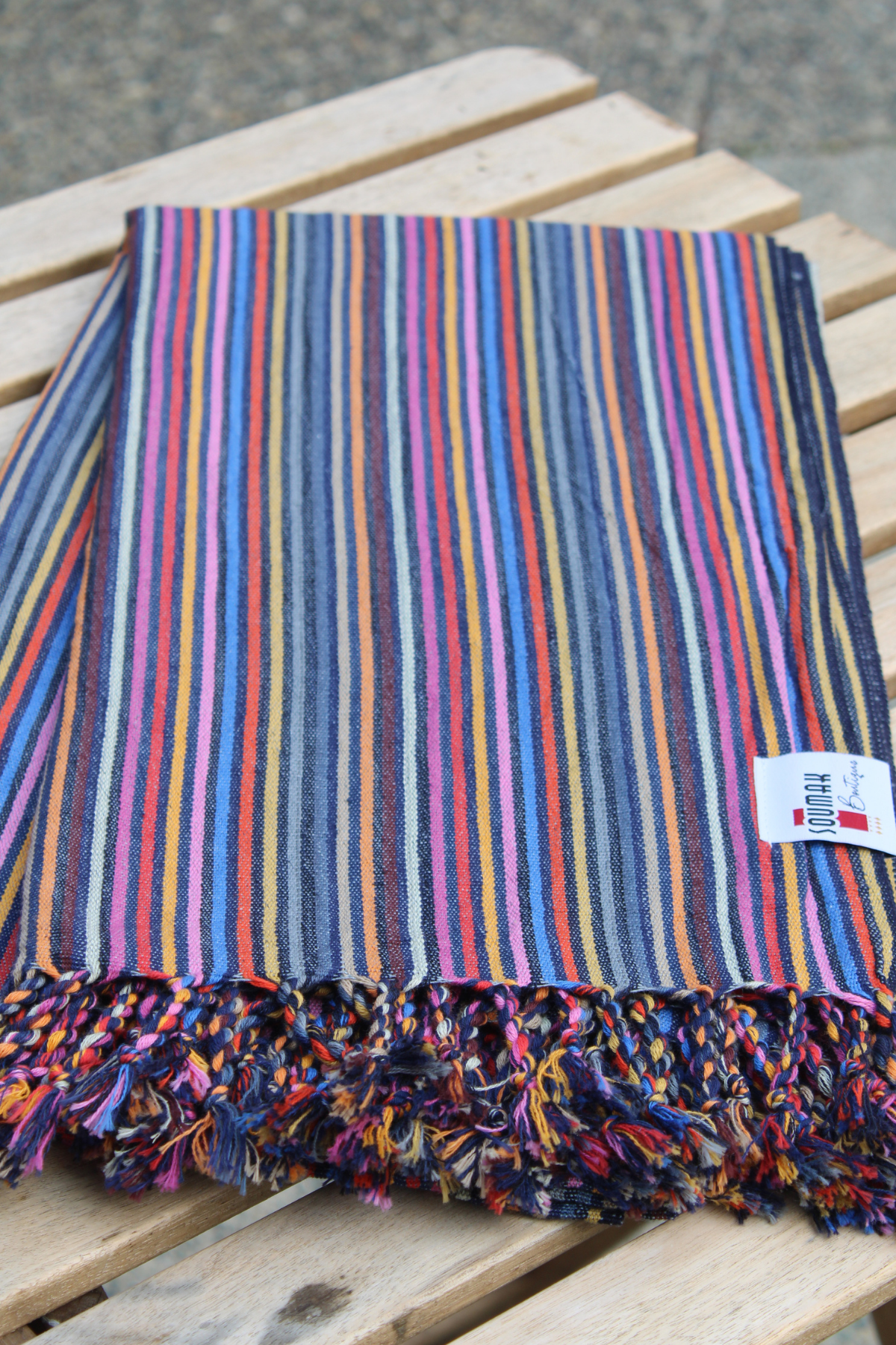 Striped colorful Turkish Towel for summer on a wooden table