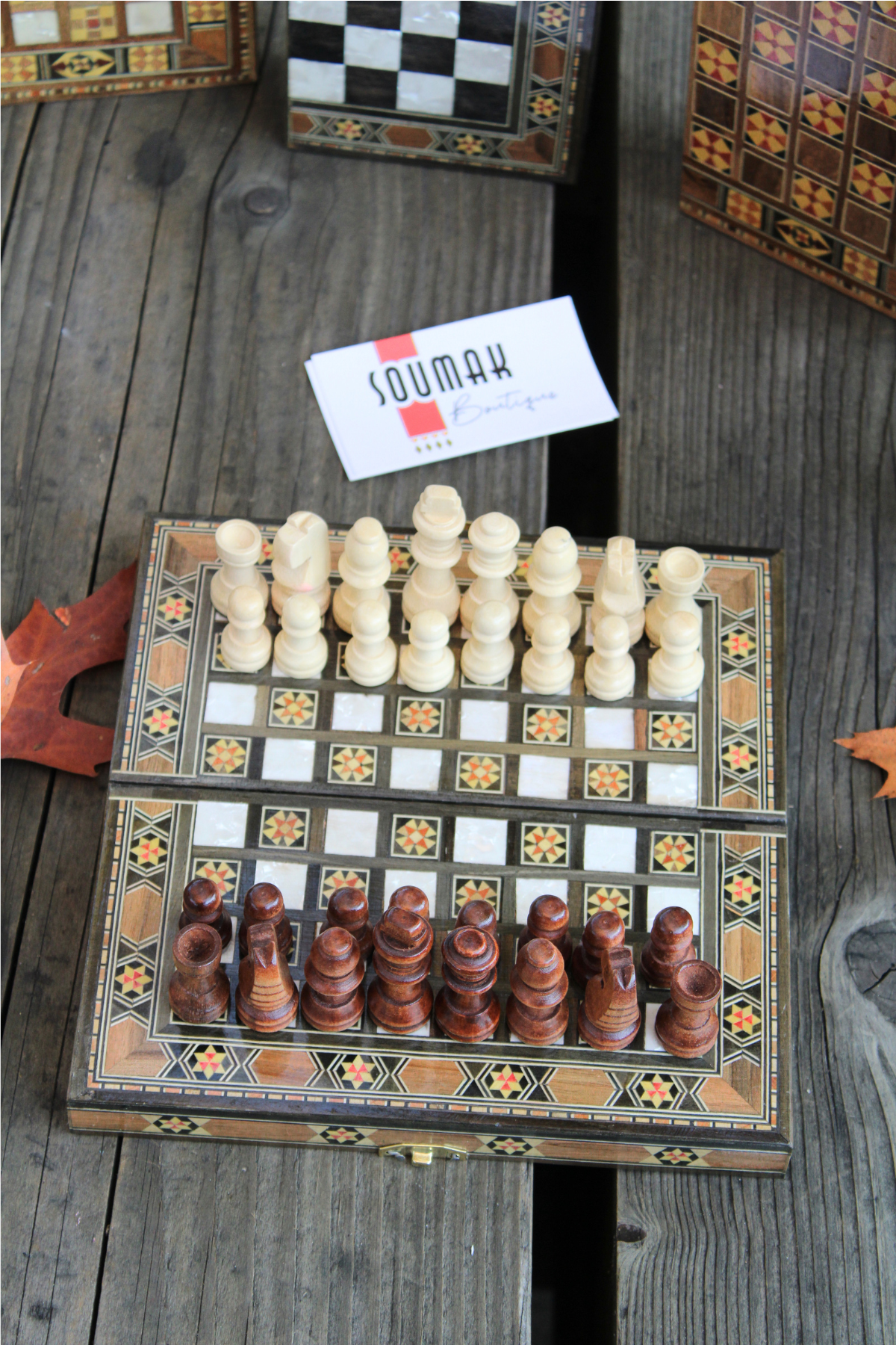 Chess side of the Mini Syrian Board adorned with intricately carved chess pieces, showcasing its unique floral design.