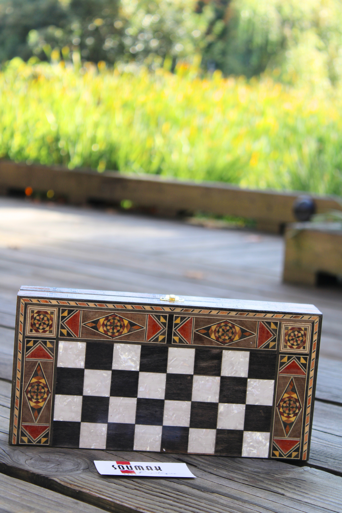 Horizontally closed view of the Classic Elegance Chess and Backgammon Board, showcasing its striking black and white square design and smooth finish. This captivating board enhances any room's decor, making it a delightful addition to your home.