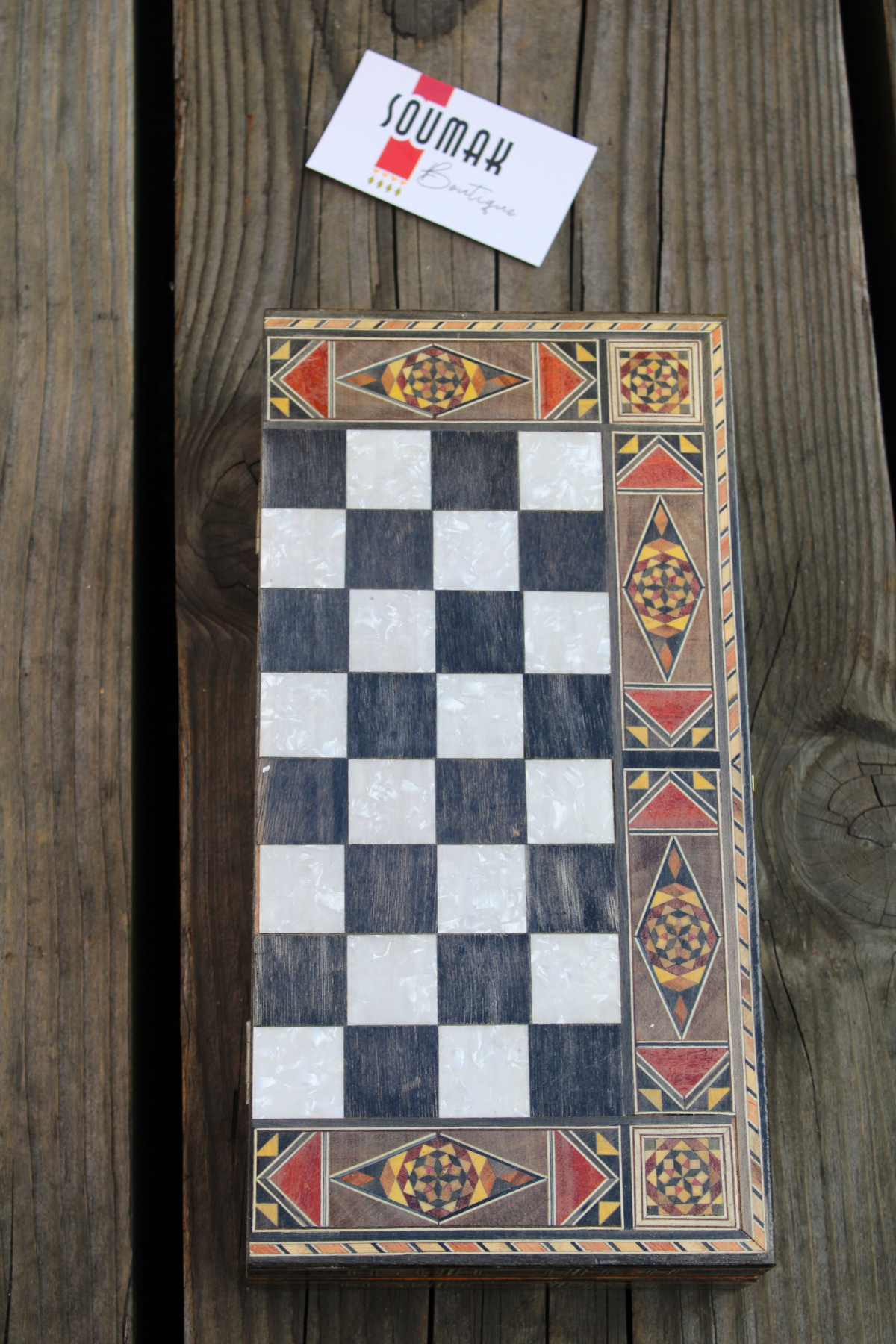 Closed view of the Classic Elegance Chess and Backgammon Board elegantly laid down, highlighting its timeless black and white squares. This beautifully crafted board adds a touch of classic sophistication to any space, perfect for display or gifting. Available at Soumak Boutique.