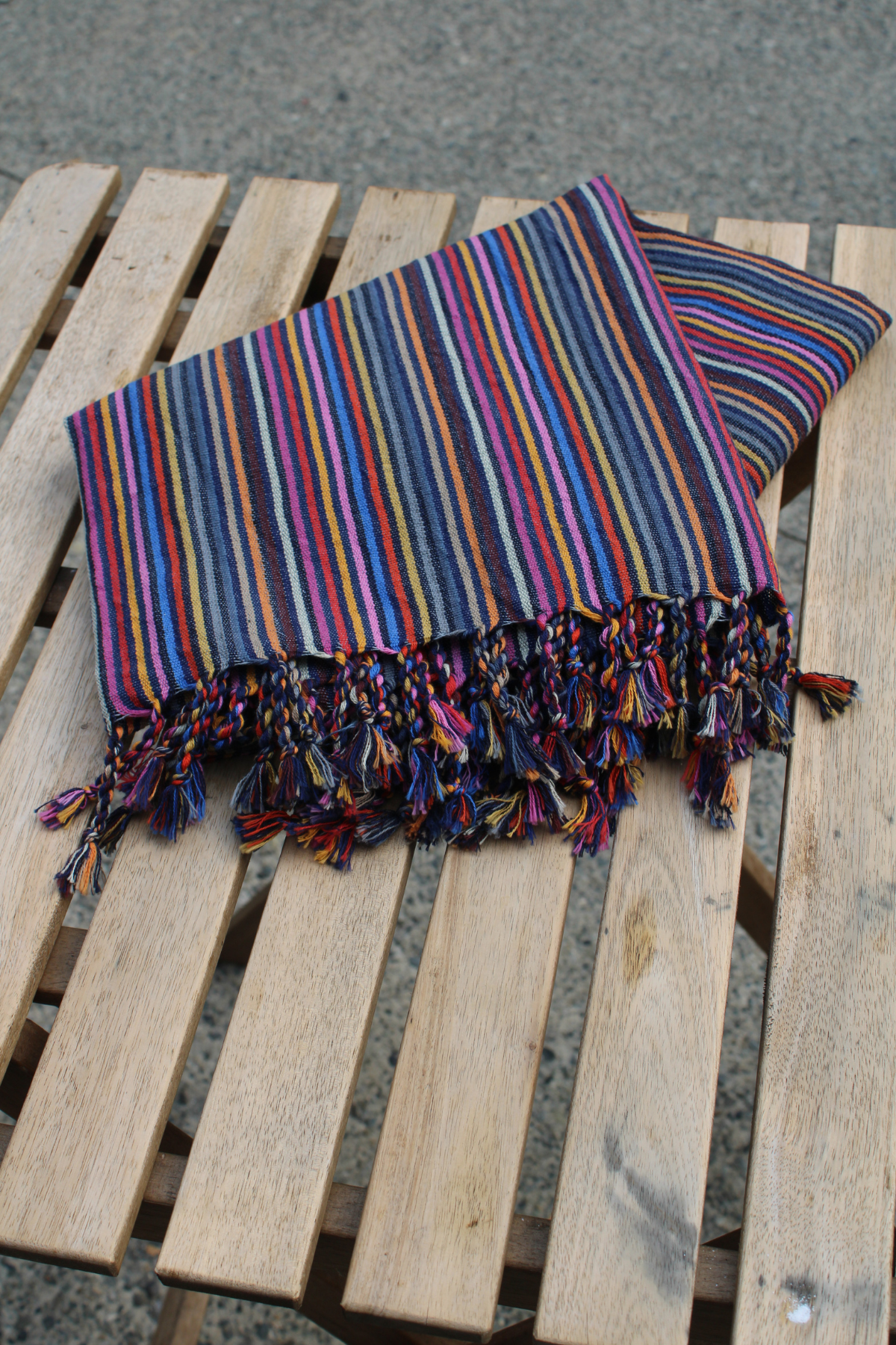 Striped colourful folded turkish towel on a wooden table
