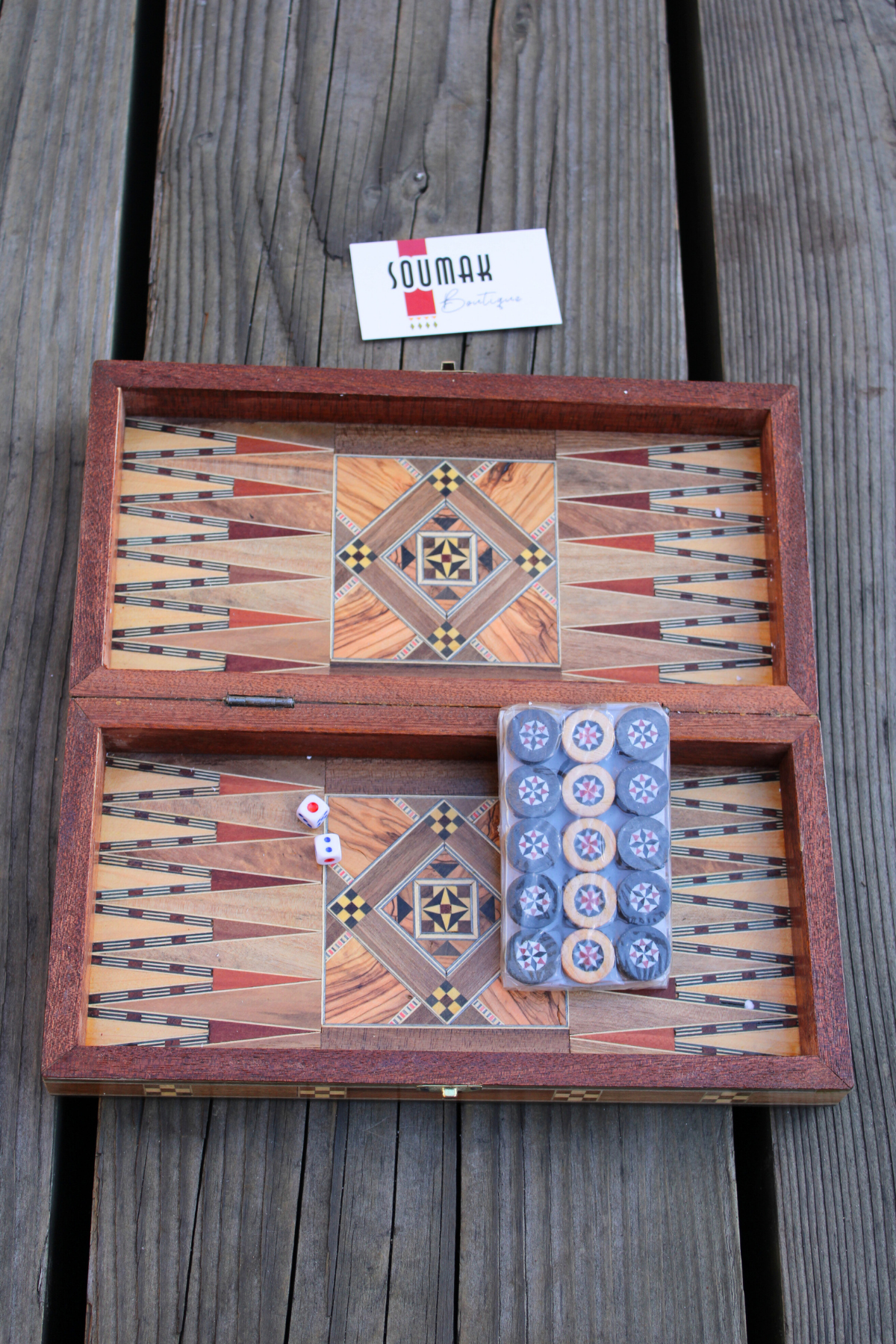 View of the backgammon side of the Golden Blossom Mosaic Chess and Backgammon Board, adorned with wooden backgammon pieces and dice. The vibrant yellow floral mosaic design adds a touch of elegance to your game night, inviting joy and camaraderie.