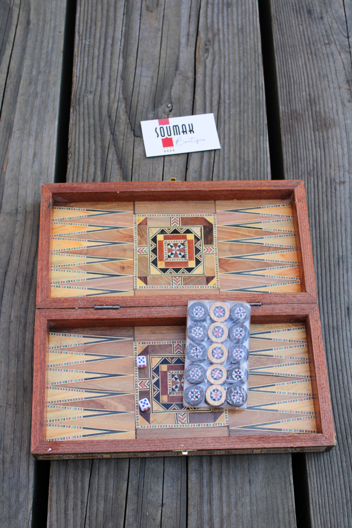 View of the backgammon side of the Jasmine Blossom Mosaic Chess and Backgammon Board, adorned with wooden backgammon pieces and dice. The floral mosaic design brings a touch of elegance to your game night, inviting fun and enjoyment.