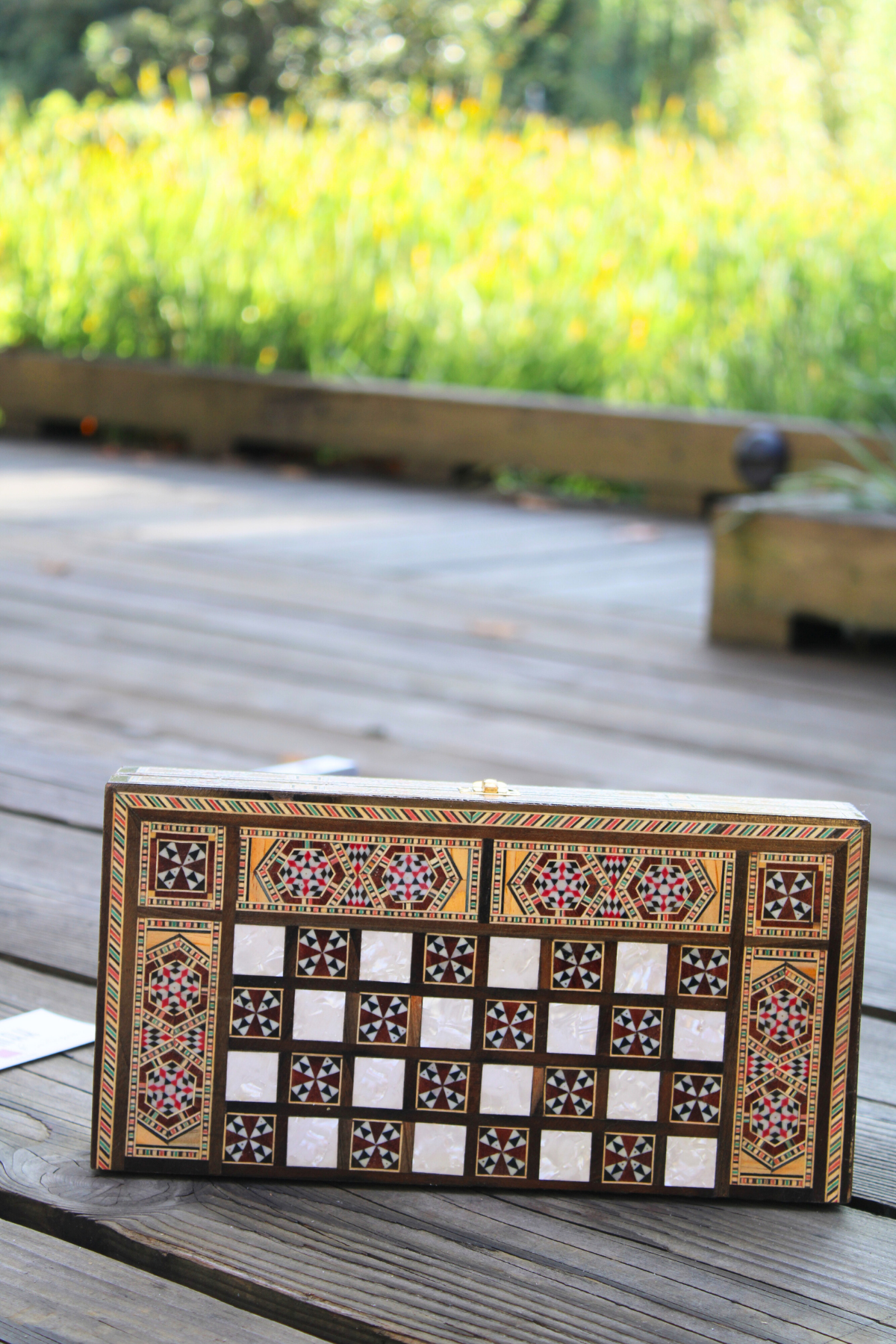 Horizontally closed view of the Jasmine Blossom Mosaic Chess and Backgammon Board, showcasing its beautiful floral mosaic and smooth finish. This exquisite board adds a touch of luxury and artistry to any room, making it a delightful addition to your home.