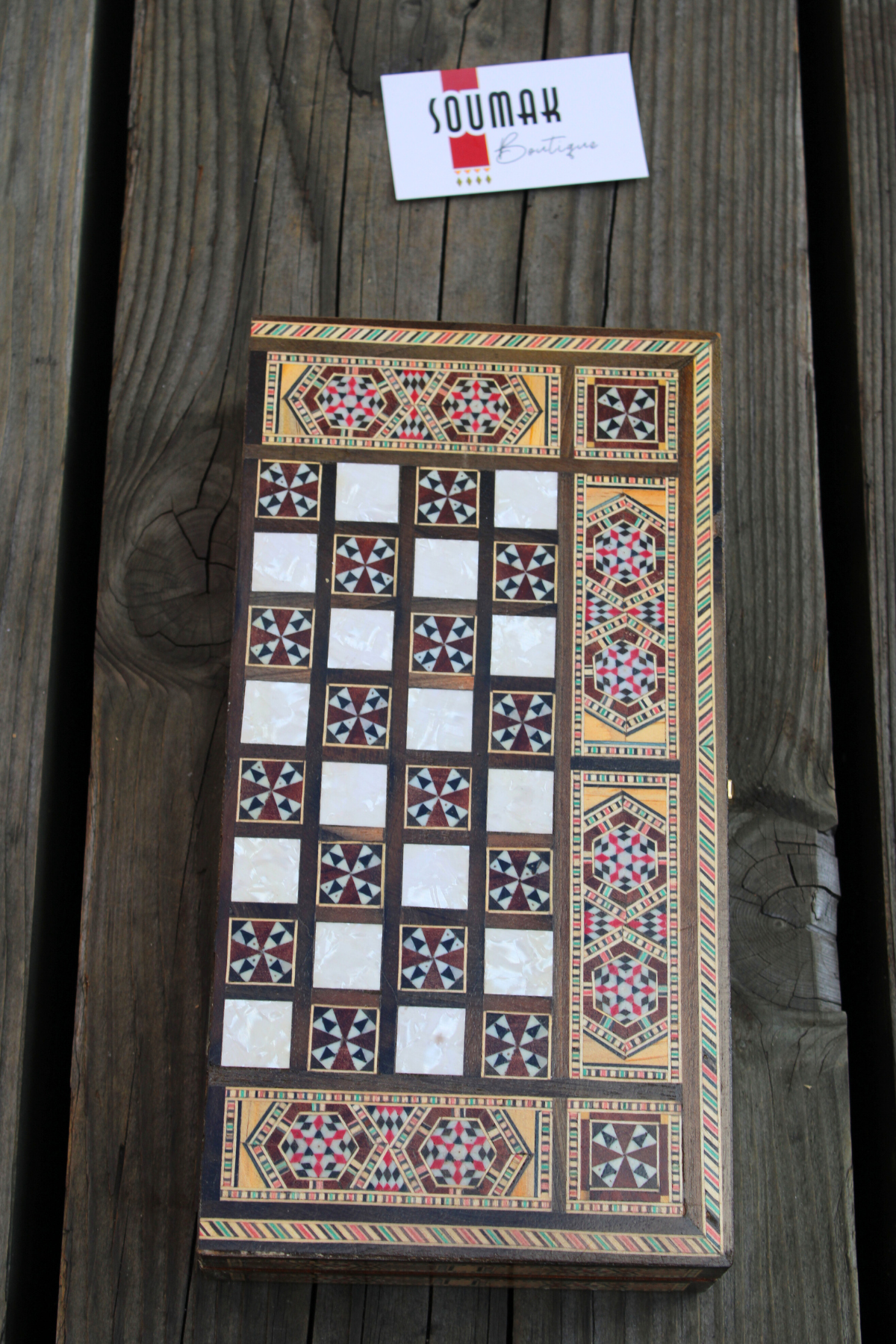 Closed view of the Jasmine Blossom Mosaic Chess and Backgammon Board elegantly laid down, showcasing its exquisite floral mosaic pattern inspired by jasmine. This beautifully crafted board adds a touch of sophistication to any space, perfect for display or gifting. Available at Soumak Boutique.