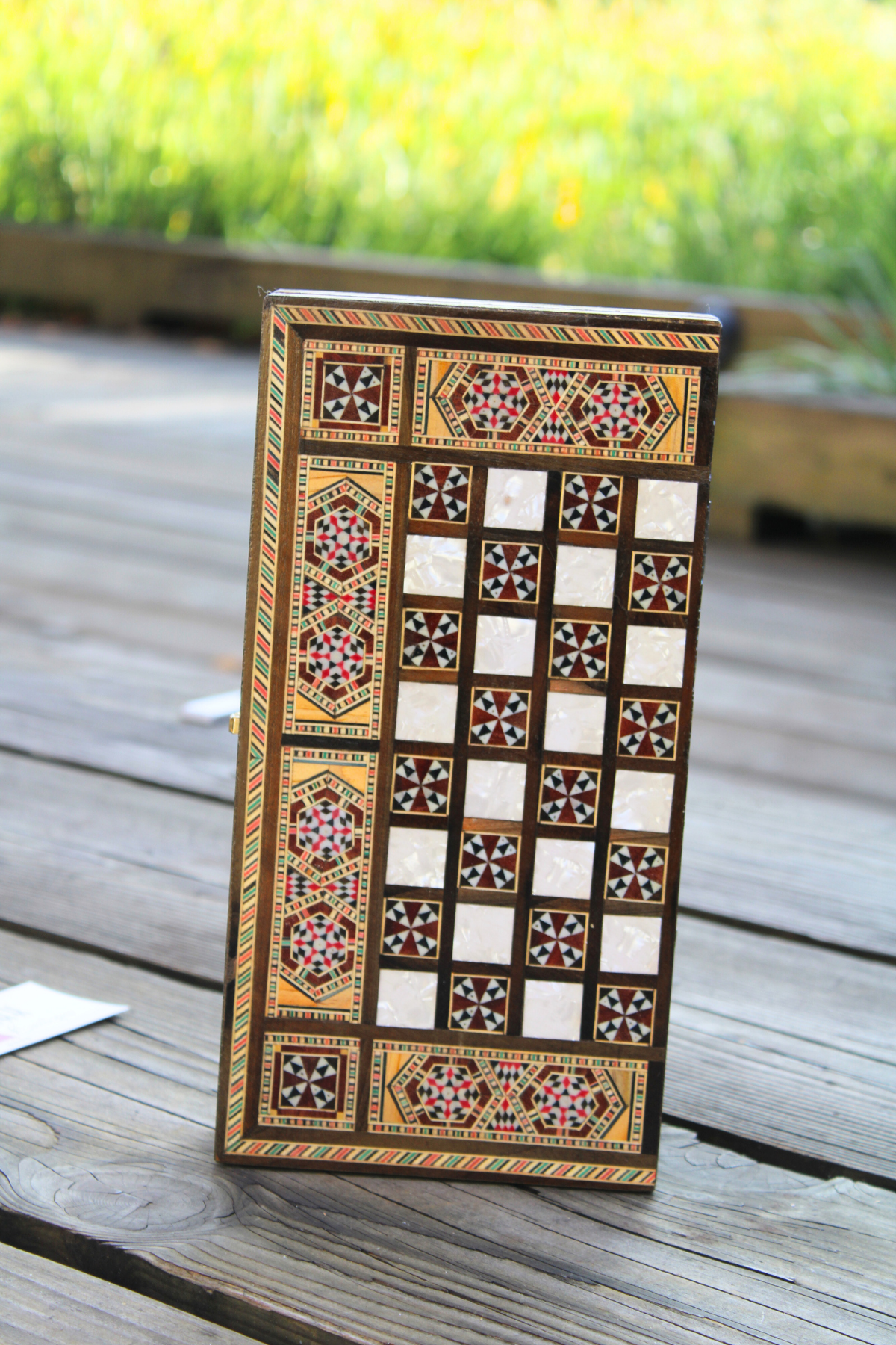 Vertically closed view of the Jasmine Blossom Mosaic Chess and Backgammon Board, highlighting its stunning floral design and high-quality craftsmanship. This captivating piece is available at Soumak Boutique, perfect for collectors and game enthusiasts alike.