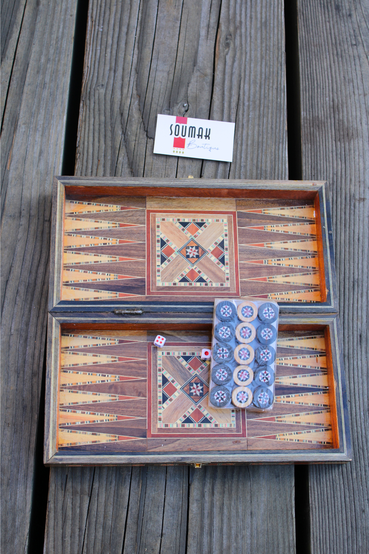 View of the backgammon side of the handcrafted Radiant Mosaic Chess and Backgammon Board, featuring wooden backgammon pieces and dice arranged on the board. Showcasing intricate design and mother of pearl inlay.