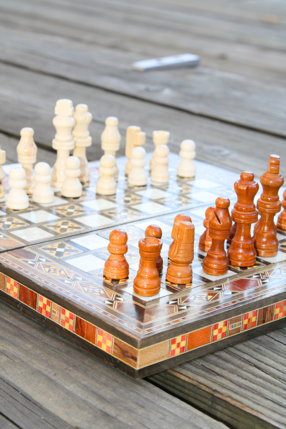 Close-up corner view of the handcrafted Radiant Mosaic Chess and Backgammon Board, highlighting its intricate design and mother of pearl inlay. Made from rosewood, oak, and lemonwood.