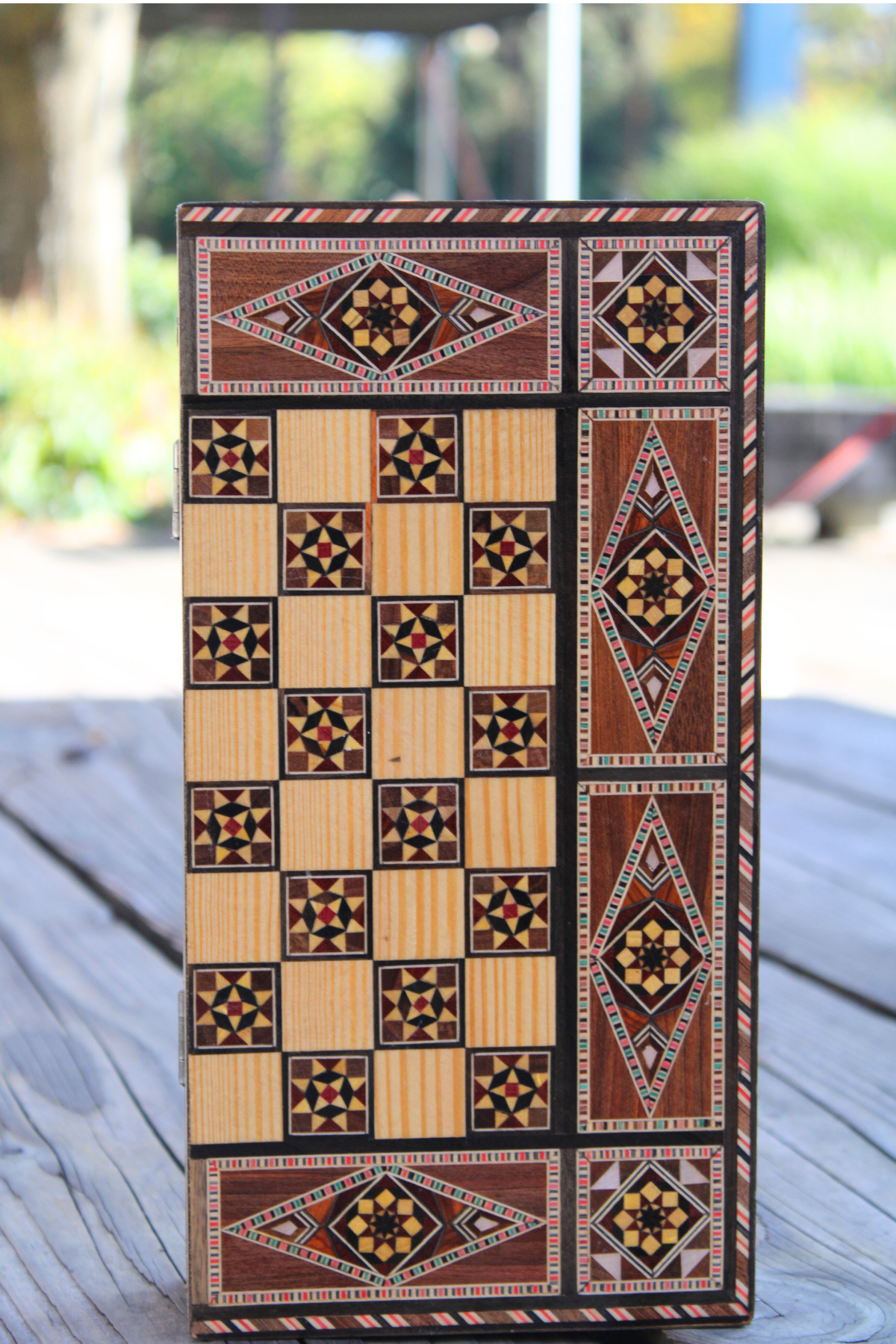 Vertical view of the closed Woodland Mosaic Chess and Backgammon Board, emphasizing its intricate wooden mosaic design. This stunning board stands out as a beautiful decorative piece, perfect for enhancing any space while offering functional gameplay.